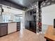 Updated kitchen featuring gray cabinets, tile floors, and stainless steel appliances, creating a modern and functional space at 1655 S Highland Ave # G164, Clearwater, FL 33756