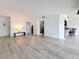 Bright living room featuring light wood floors and an open layout to the kitchen and hallway at 1655 S Highland Ave # G164, Clearwater, FL 33756