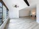Sunlit living room has sleek floors and a bank of windows offering views of the exterior foliage at 1655 S Highland Ave # G164, Clearwater, FL 33756