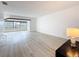 Open-concept living area with laminate floors and bright natural lighting at 1655 S Highland Ave # G164, Clearwater, FL 33756