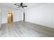 Bright living room featuring sleek floors, ceiling fan and entry to bathroom at 1655 S Highland Ave # G164, Clearwater, FL 33756