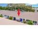 Exterior shot of a condo patio with seating, planters, and an awning for shade at 1655 S Highland Ave # G164, Clearwater, FL 33756