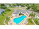 Aerial view of pool with tables and chairs and the clubhouse at 1655 S Highland Ave # G164, Clearwater, FL 33756