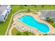 Aerial view of the inviting pool area with blue lounge chairs and tables, surrounded by well-kept lawns at 1655 S Highland Ave # G164, Clearwater, FL 33756