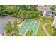 Aerial view showcasing the shuffleboard courts amidst a park-like setting with lush trees at 1655 S Highland Ave # G164, Clearwater, FL 33756