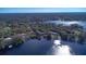 Wide aerial view of a lakefront community with private docks and lush trees, offering serene waterfront living at 16573 Hutchison Rd, Odessa, FL 33556