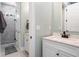Stylish bathroom with marble countertops, white cabinetry, and a glass-enclosed shower with stone accents at 16573 Hutchison Rd, Odessa, FL 33556