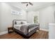 Bright bedroom featuring a dark metal frame bed, hardwood floors, and ample natural light at 16573 Hutchison Rd, Odessa, FL 33556
