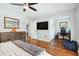 This spacious bedroom features hardwood floors, a ceiling fan, and an en-suite office space, for work or relaxation at 16573 Hutchison Rd, Odessa, FL 33556