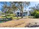 This lovely home boasts a lakefront view, spacious yard, private dock, screened porch, and inviting curb appeal at 16573 Hutchison Rd, Odessa, FL 33556