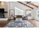 Comfortable living area featuring wood flooring, exposed beams, fireplace and neutral colored furniture at 16573 Hutchison Rd, Odessa, FL 33556