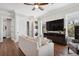 Cozy living room with hardwood floors, large TV, comfortable seating, and a convenient washer/dryer at 16573 Hutchison Rd, Odessa, FL 33556
