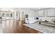 Bright and airy living room featuring hardwood floors, a plush white sofa, and stylish decor at 16573 Hutchison Rd, Odessa, FL 33556