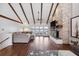 Large living room with wood floors, brick fireplace, a beamed ceiling, and access to the lake at 16573 Hutchison Rd, Odessa, FL 33556
