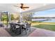 This covered patio offers stunning lake views, an outdoor dining area, and plenty of space for relaxation and entertaining at 16573 Hutchison Rd, Odessa, FL 33556