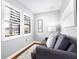 Cozy sitting area features hardwood flooring, large windows with shutters, and a comfortable couch at 16573 Hutchison Rd, Odessa, FL 33556