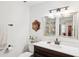 Bathroom featuring a dark wood vanity, bright lighting, and decorative mirror at 1904 Canterbury Ln # 21, Sun City Center, FL 33573