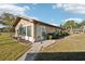 Exterior angle of the home showing well-kept lawn and landscaping at 1904 Canterbury Ln # 21, Sun City Center, FL 33573