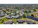 An aerial view of a Florida neighborhood featuring single-Gathering homes, ponds, and lush landscaping at 206 Glenellen Pl, Sun City Center, FL 33573