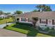 Well-maintained home featuring bright red shutters and lush, landscaped yard at 206 Glenellen Pl, Sun City Center, FL 33573