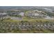 Overhead shot showing community homes by a golf course and ponds, nestled in lush greenery at 2129 Acadia Greens Dr, Sun City Center, FL 33573