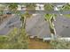A serene aerial view of a single-Gathering home showcases its well-kept roof and verdant yard at 2129 Acadia Greens Dr, Sun City Center, FL 33573