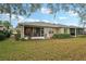 Scenic backyard featuring a lanai and lush landscaping at 2129 Acadia Greens Dr, Sun City Center, FL 33573