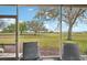 Tranquil backyard view from the screened lanai overlooking the lush green golf course at 2129 Acadia Greens Dr, Sun City Center, FL 33573