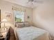 Comfortable bedroom with a ceiling fan, window, and dresser at 2129 Acadia Greens Dr, Sun City Center, FL 33573