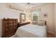 Warm bedroom with ceiling fan, window, and classic wood furniture at 2129 Acadia Greens Dr, Sun City Center, FL 33573