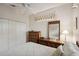 Bright bedroom featuring a ceiling fan, closet, and wooden dresser at 2129 Acadia Greens Dr, Sun City Center, FL 33573