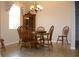 Traditional dining room with wood table set beneath an elegant chandelier by a window at 2129 Acadia Greens Dr, Sun City Center, FL 33573