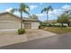 Well-maintained home featuring a two-car garage, landscaped front yard, and a welcoming driveway, perfect for suburban living at 2129 Acadia Greens Dr, Sun City Center, FL 33573