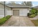 Inviting home featuring a two-car garage, mature landscaping, and a well-maintained driveway, perfect for suburban charm at 2129 Acadia Greens Dr, Sun City Center, FL 33573