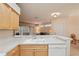 Open kitchen with white countertops, sink, and dishwasher; view of living room at 2129 Acadia Greens Dr, Sun City Center, FL 33573