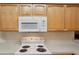 Well lit kitchen featuring GE microwave, and white oven range with bright white countertops at 2129 Acadia Greens Dr, Sun City Center, FL 33573