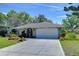 Well-maintained home featuring a spacious driveway, mature landscaping and a two-car garage at 22240 Stillwood Dr, Land O Lakes, FL 34639