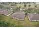 Aerial view of homes nestled in a serene community with lush greenery, ponds, and mature trees at 2243 Worthington Greens Dr, Sun City Center, FL 33573