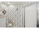 Bathroom featuring a shower, toilet, and floral patterned wallpaper at 2243 Worthington Greens Dr, Sun City Center, FL 33573