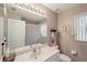 Full bathroom with floral wallpaper, a large mirror, and a shower with curtain at 2243 Worthington Greens Dr, Sun City Center, FL 33573