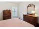 Charming bedroom with a wooden dresser with window and natural light at 2243 Worthington Greens Dr, Sun City Center, FL 33573