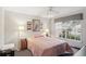 Cozy bedroom with ceiling fan, window with blinds, and nautical themed decorations at 2243 Worthington Greens Dr, Sun City Center, FL 33573