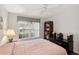 Relaxing bedroom featuring a ceiling fan, bookcase, and backyard view at 2243 Worthington Greens Dr, Sun City Center, FL 33573