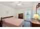 Cozy bedroom with a comfortable bed, dresser, and window with curtains at 2243 Worthington Greens Dr, Sun City Center, FL 33573