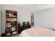 Bedroom showcasing a built-in bookcase and adjacent hallway entrance at 2243 Worthington Greens Dr, Sun City Center, FL 33573