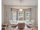 Bright dining area featuring a decorative light fixture and large window at 2243 Worthington Greens Dr, Sun City Center, FL 33573