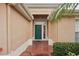 Inviting front entrance with a brick pathway leading to a stylish green door with sidelights at 2243 Worthington Greens Dr, Sun City Center, FL 33573