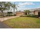 Charming single-story home with well-maintained landscaping and a spacious front yard with mature trees at 2243 Worthington Greens Dr, Sun City Center, FL 33573