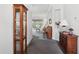 Inviting hallway with neutral paint, plush carpet, and decorative furniture leading to a bright living area at 2243 Worthington Greens Dr, Sun City Center, FL 33573