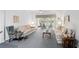 Cozy living room with plush carpeting, comfortable seating, and sliding doors to an outdoor patio at 2243 Worthington Greens Dr, Sun City Center, FL 33573